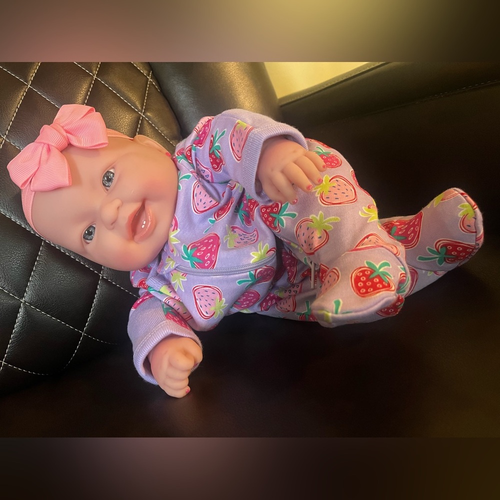 Weighted baby doll, she’s approximately 3lbs, 2oz, and wears preemie clothing.